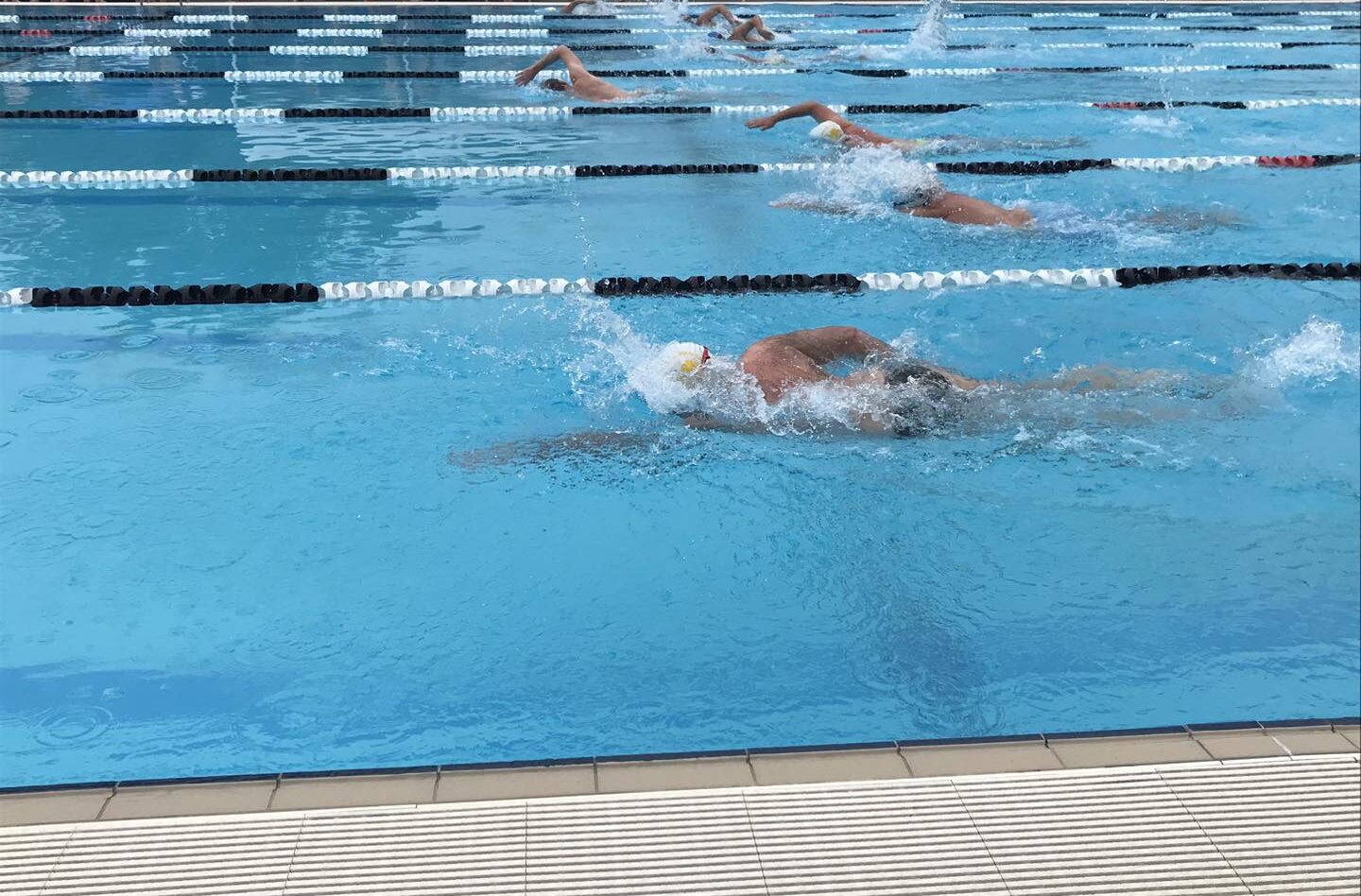 People swimming in the 50m outdoor heated swimming pool at Tomaree Aquatic Centre