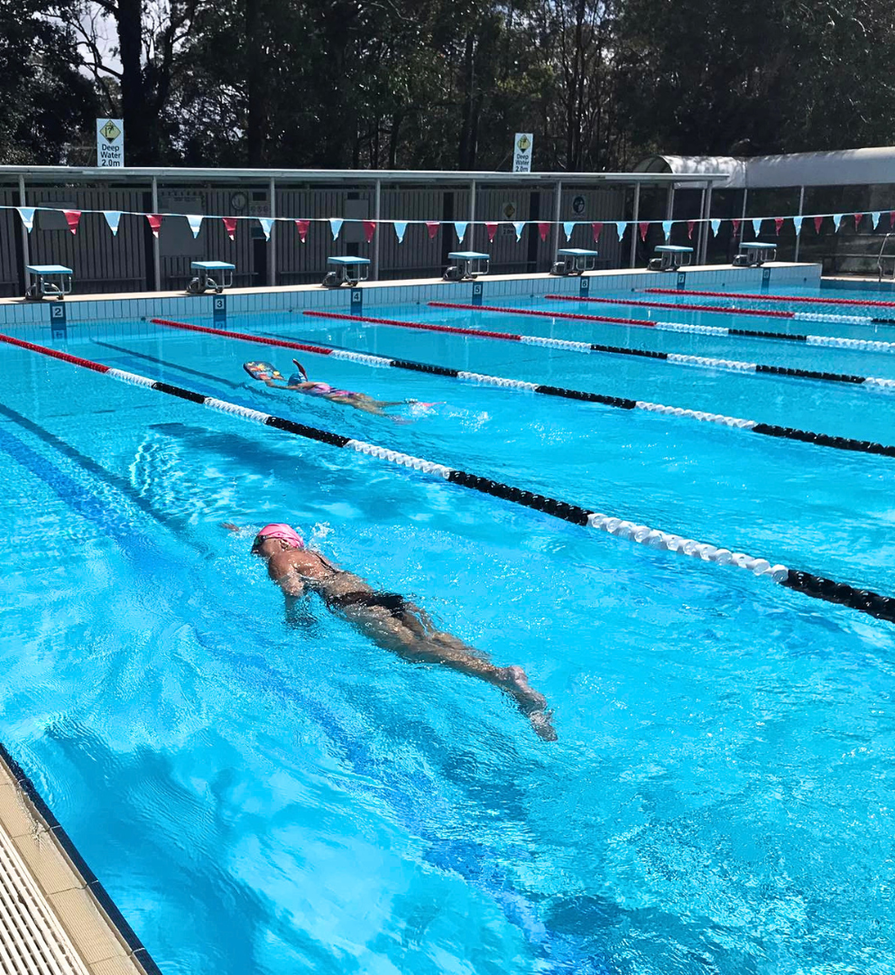 Image shows a person swimming in the 50-metre heated outdoor swimming pool at Tomaree Aquatic Centre where they provide swimming lessons.
